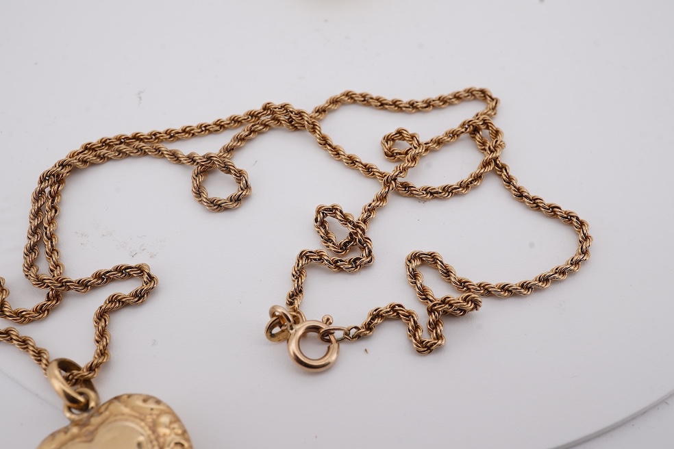 A modern embossed 9ct gold heart shaped locket, 21mm, on a similar 9ct gold rope twist chain, 46cm, together with one other yellow metal heart shaped locket, on a yellow metal chain, gross weight 14.5 grams. Condition -